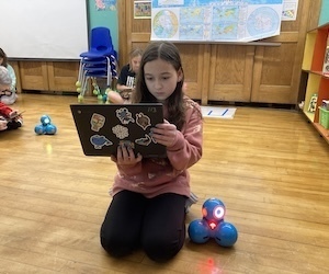 student with dash robot